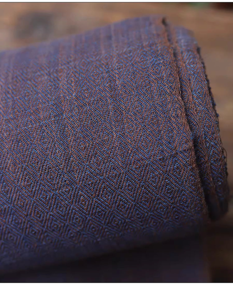 Close-up of textured blue fabric with a geometric pattern on a blurred background